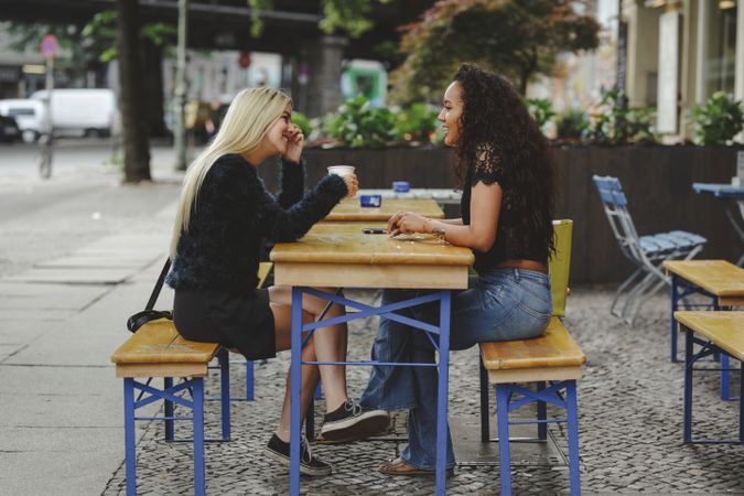 Friends talking in street cafe