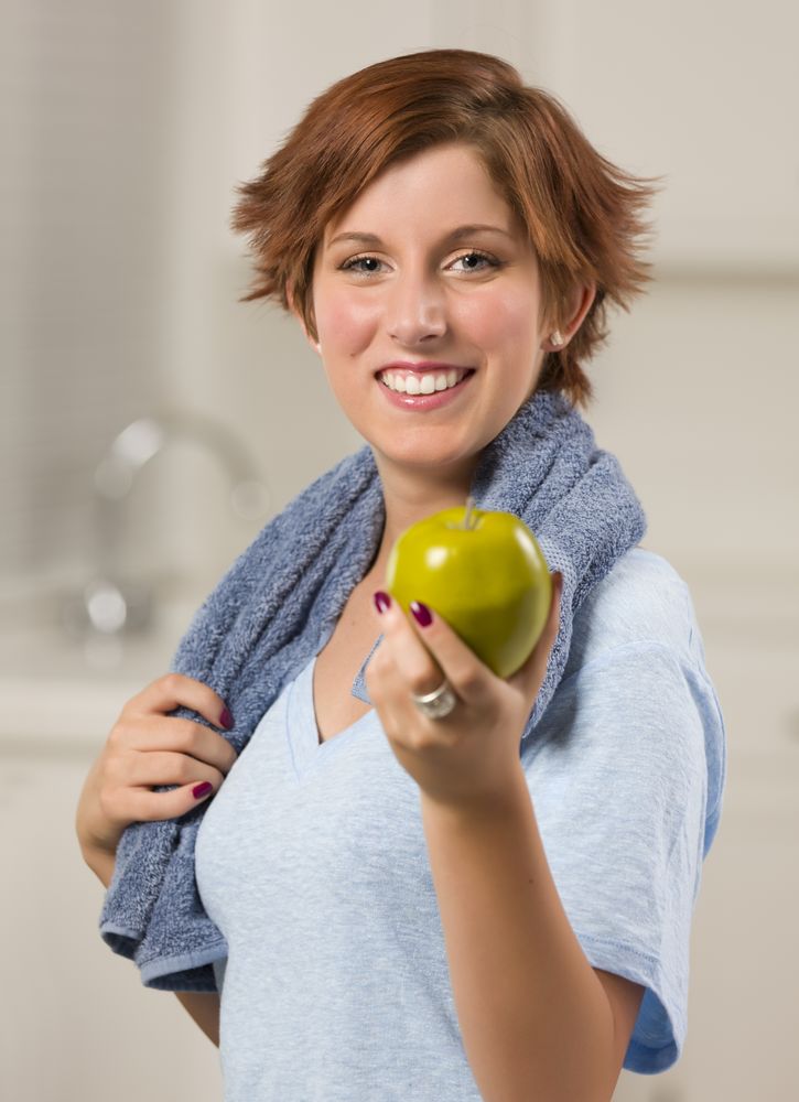 Red Haired Woman with Towel Holding Green Apple