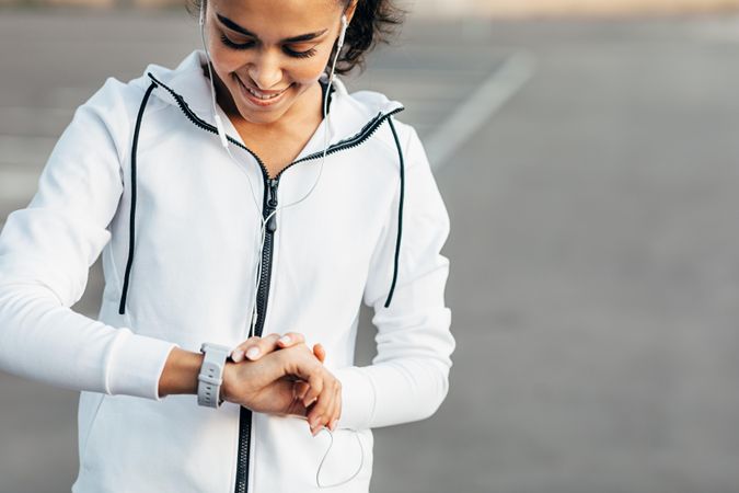 Happy woman looking at her wrist with a smartwatch
