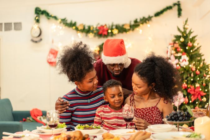 Portrait of a Black family, festive dinner table at Christmas