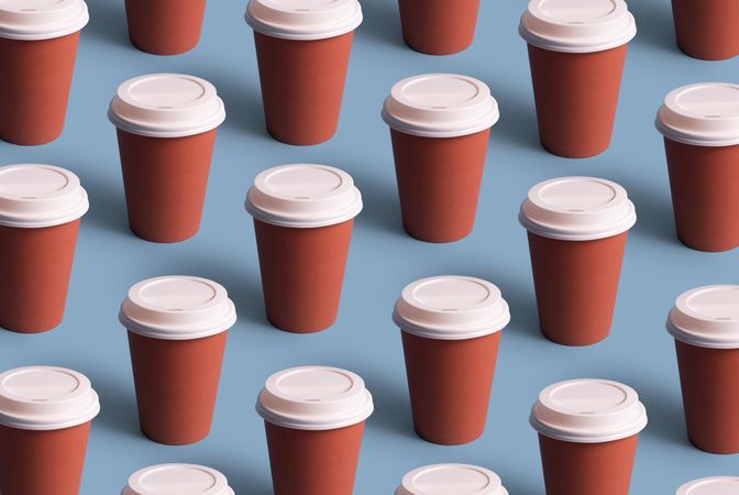 Disposable coffee cups on blue background