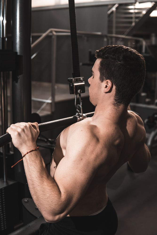Young fitness man training in gym