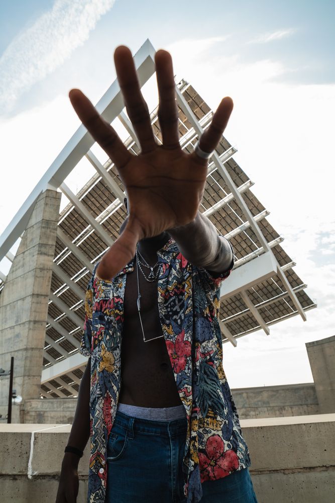 Stylish Black man with stop gesture