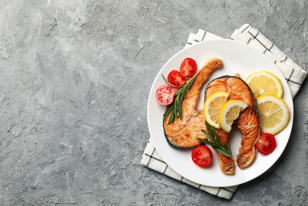 Composition with tasty grilled salmon on gray background, top view