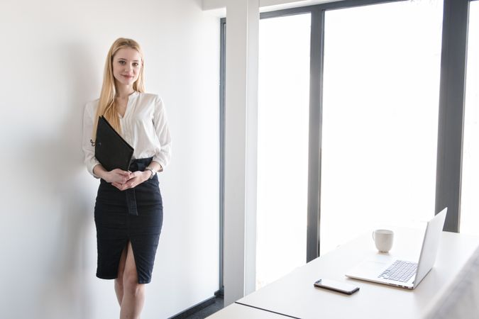 Smiling woman using tablet in office