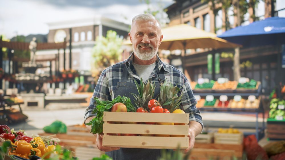Portrait of a  Street Vendor Working at a Farmers Market Stall with Fresh Agricultural Products.