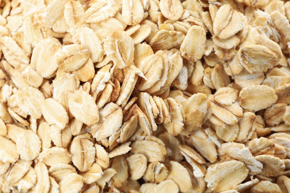 Oatmeal flakes texture on whole background, close up