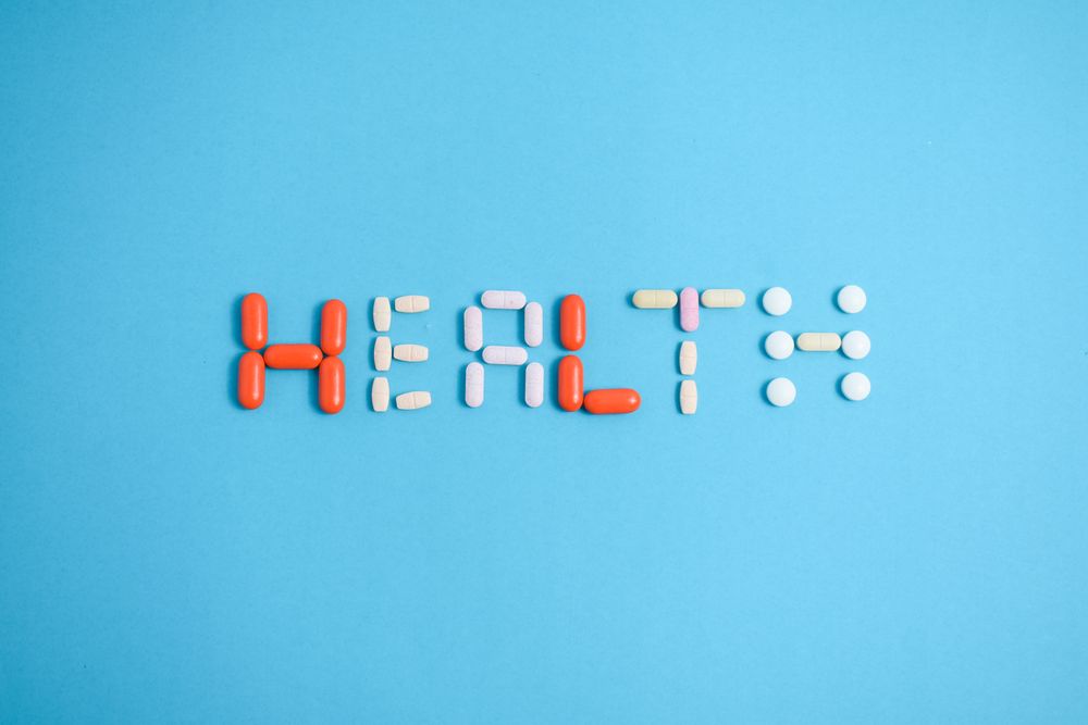 Multiple pills spelling the word "HEALTH"
