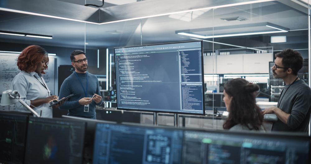 Team of Diverse Software Developers Having a Meeting in Order to Review the Code Done by Computer Engineering Department.
