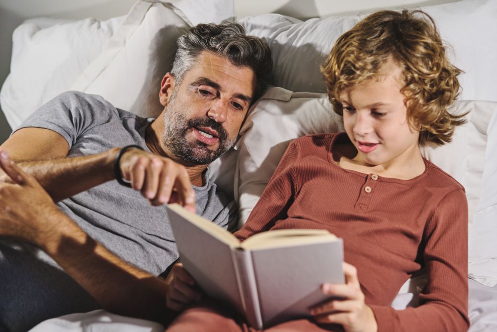 Father and son reading bed time story