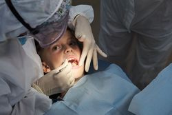 Child having teeth examined by dentist
