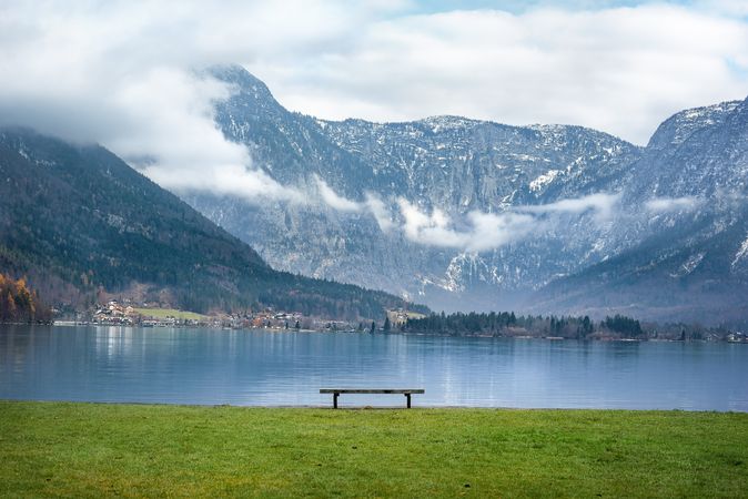 Austrian Alps and a bench on calm lakeside