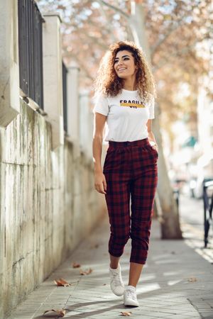 Portrait of smiling Arab woman walking outside