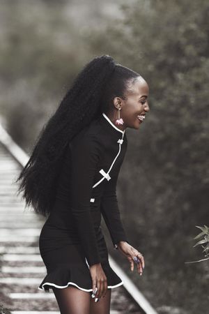 Woman in formal dark dress smiling outdoor