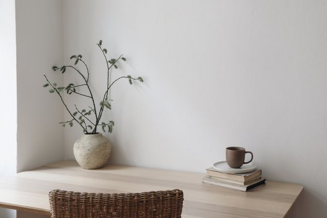 Desk with vase, coffee and books
