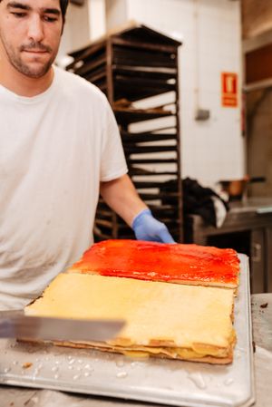 Baker with freshly glazed cakes