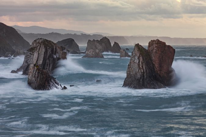Storm with blustering waves on rocky coast