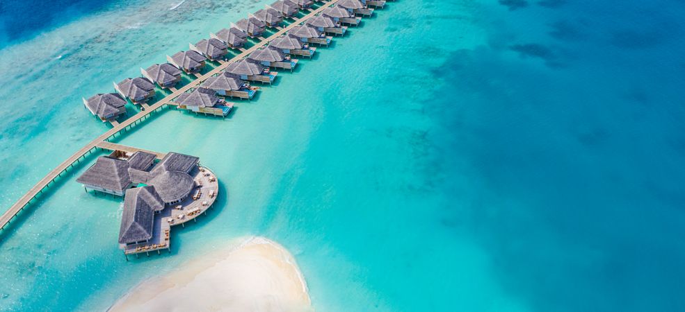 Wide shot of overwater bungalow, with copy space