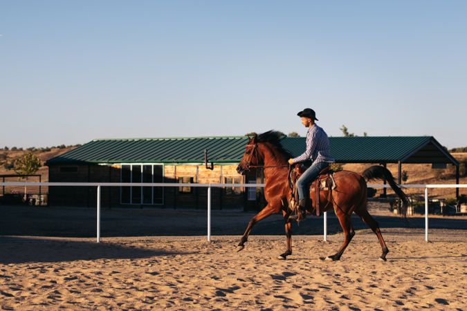 Man riding a horse in an equestrian center