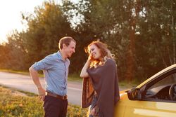 Couple talk and rest on the side of the quiet road