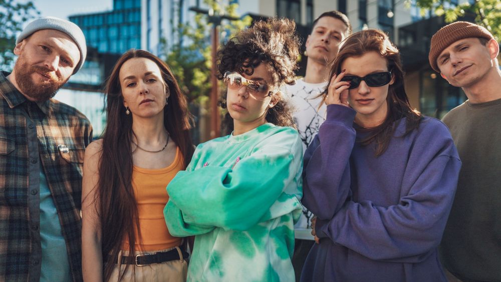 A Diverse Group Of Young Adults In Casual, Colorful Attire Stands