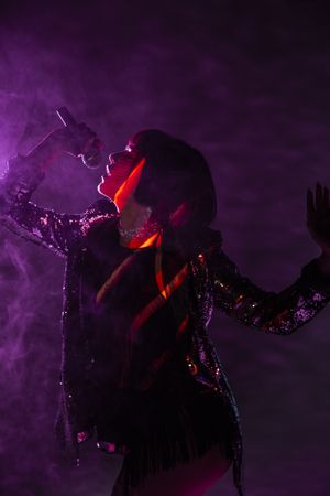 Stylish woman singing on stage