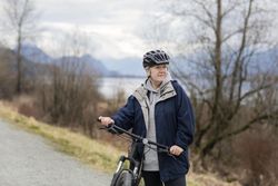 Woman with a bicycle looking to the side