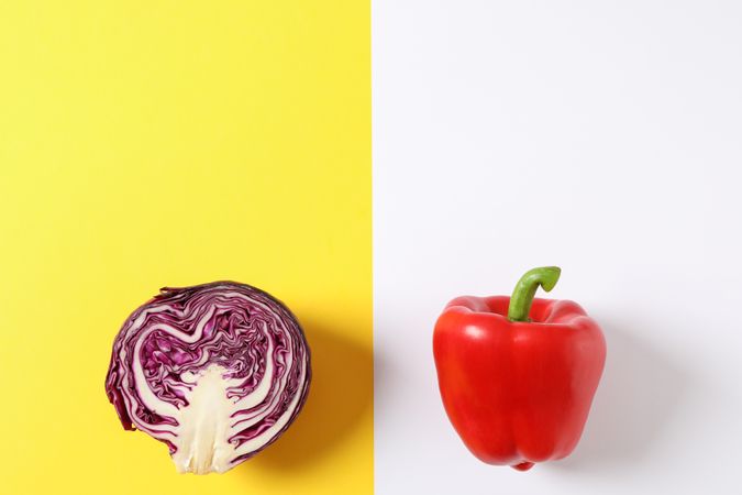 Cabbage and pepper on two tone background, space for text