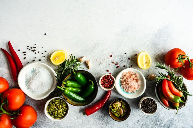 Top view of seasoning with tomatoes, garlic & herbs on counter with copy space