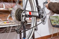 Real bicycle mechanic repairing custom fixie bike