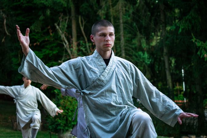 Focused male practicing balance during martial arts training