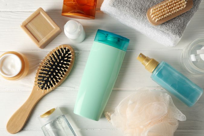 Composition with hair care products on wooden table. Blank space for label
