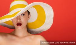 Beauty shot of young woman wearing floppy hat 4d1xdb