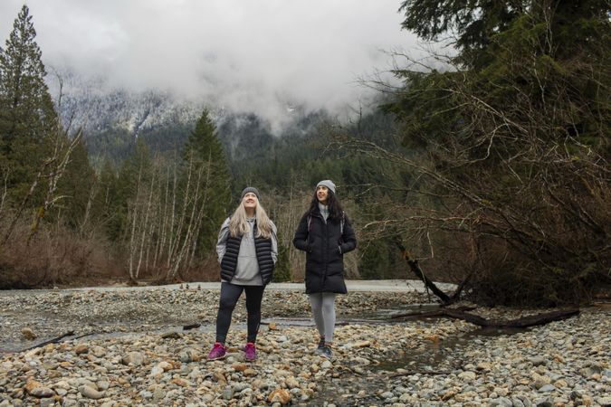 Two content women enjoying scenery on mountain hike