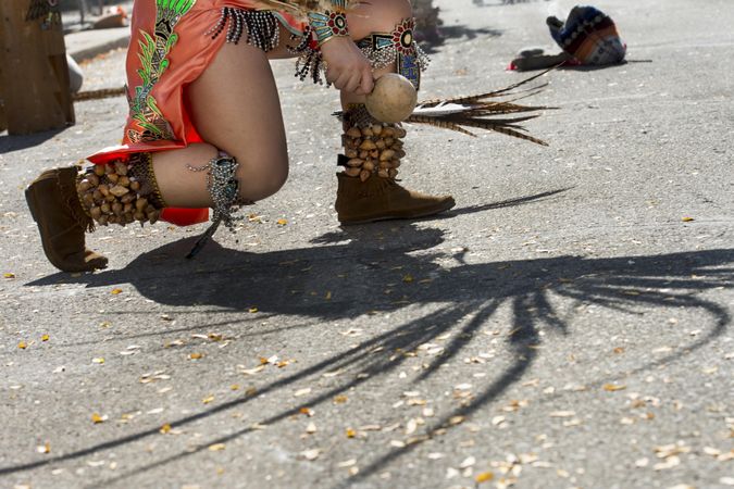 Des Moines, Iowa, USA - September 26, 2015:  An Aztec dancer kneels during a performance