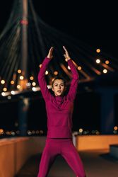 Female athlete in front of bridge at night