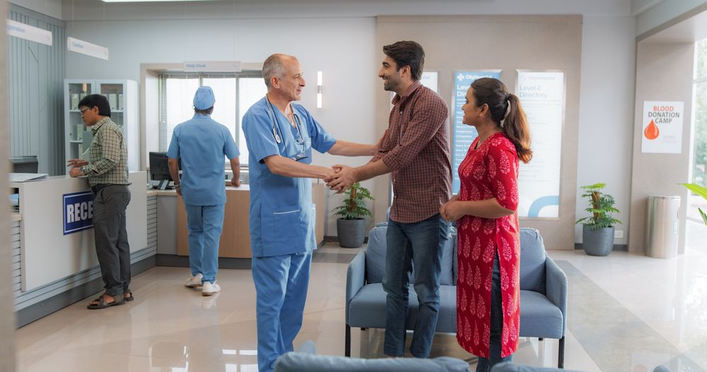 Young Husband and Wife Talking to Their Doctor, Discussing Fertility Treatment Options