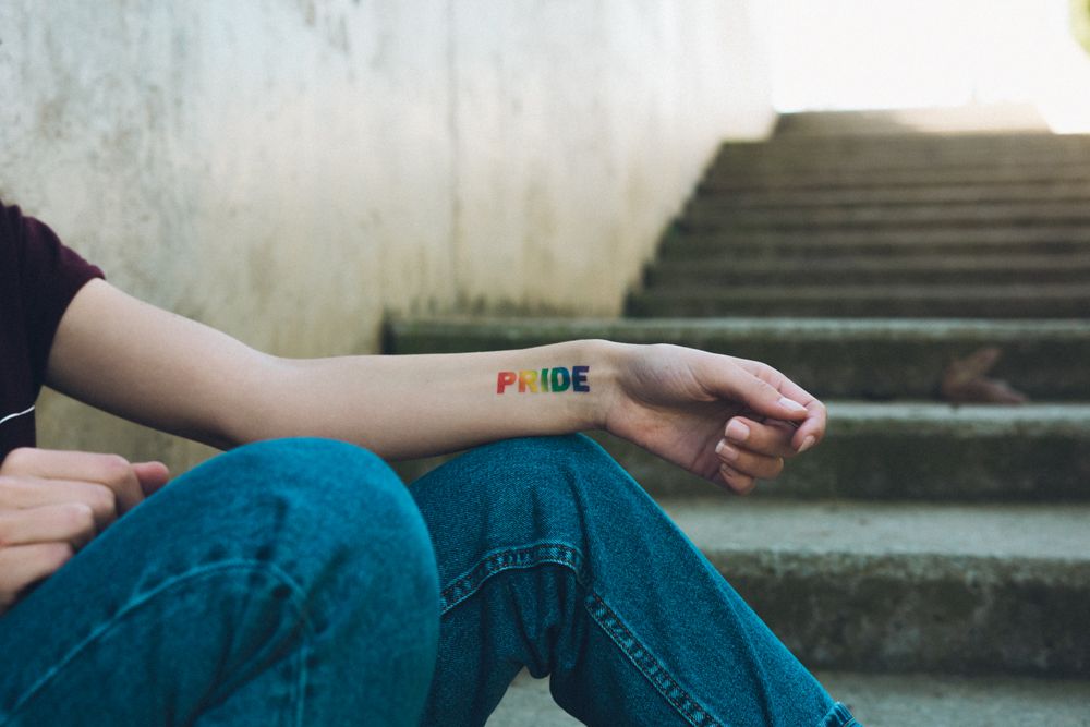 Woman with rainbow pride tattoo.