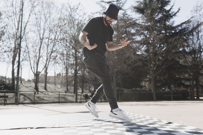 Man dancing break dance in park