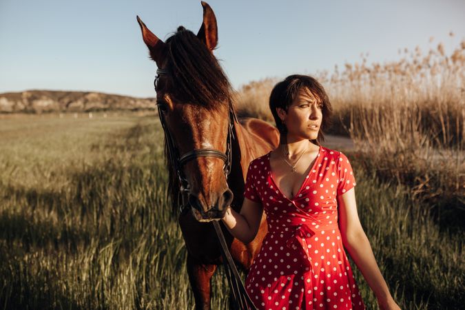 Young woman with horse on ranch