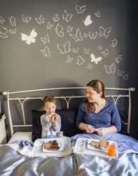 Mother and son having breakfast in bed