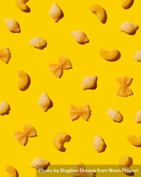 Multiple types of pasta over yellow background 0y9dj0