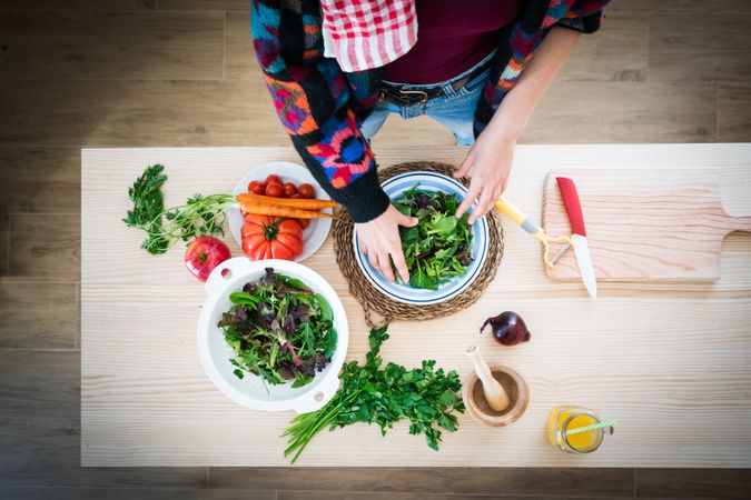 Woman preparing vegetable salad