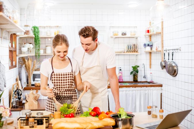 Cute couple learning to cook in the kitchen at home