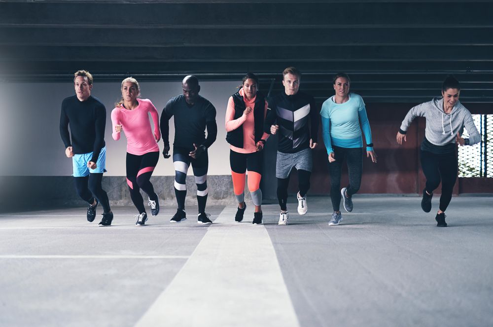 Group of people in athletic gear running towards the camera
