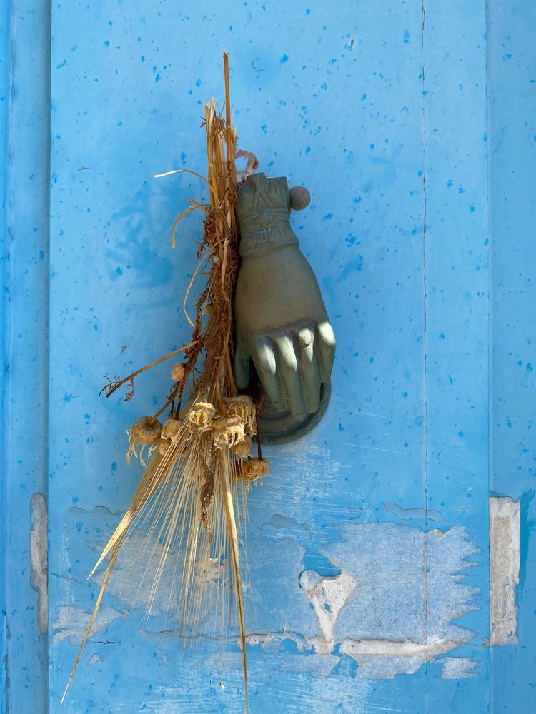 Patmian knocker close up of hand with dried bouquet