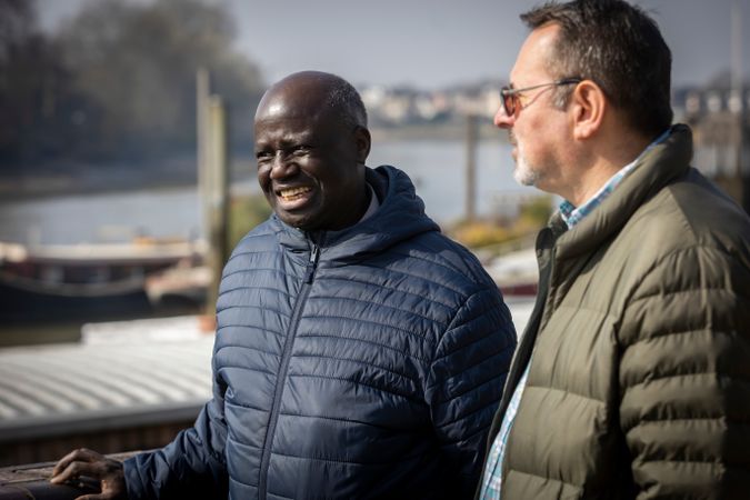 Two men chatting by the river
