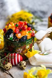 Easter fruit cake with Easter eggs and spring flowers
