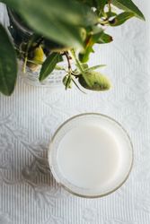 Glass of almond milk on kitchen table