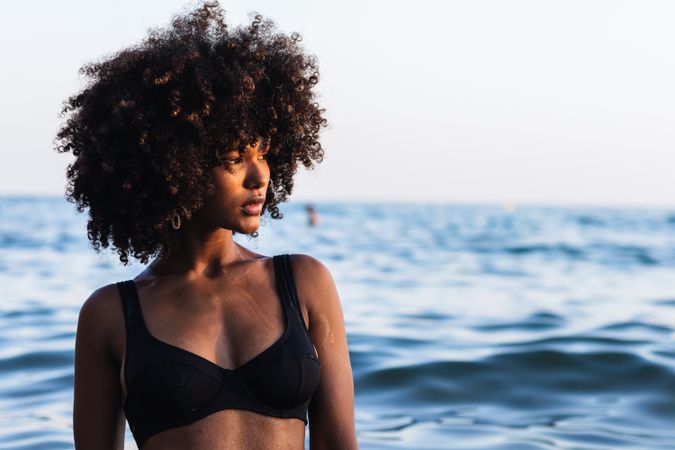 Calm Black woman in bikini in sea